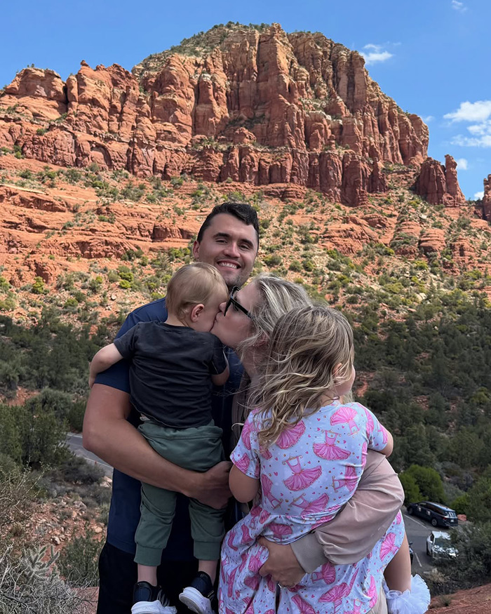 Family embracing outdoors with red rock cliffs in the background, highlighting Erika Kirk Turning Point USA CEO transition.