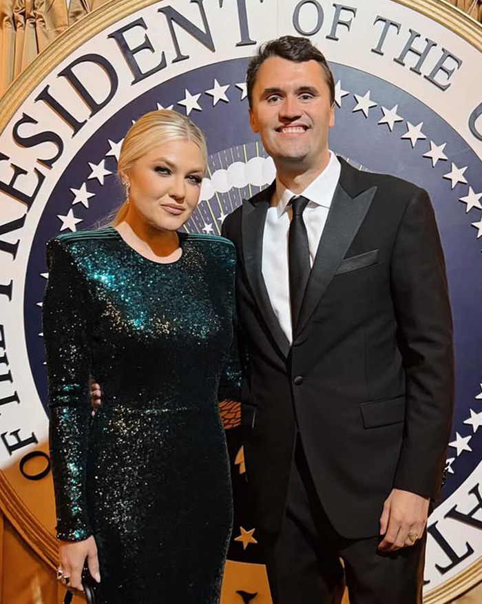 Erika Kirk and a man dressed formally standing in front of a presidential seal at a formal event.