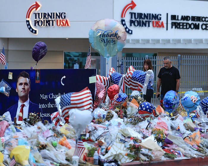 Memorial outside Turning Point USA headquarters with flowers and balloons after founder's passing and Erika Kirk appointed CEO.