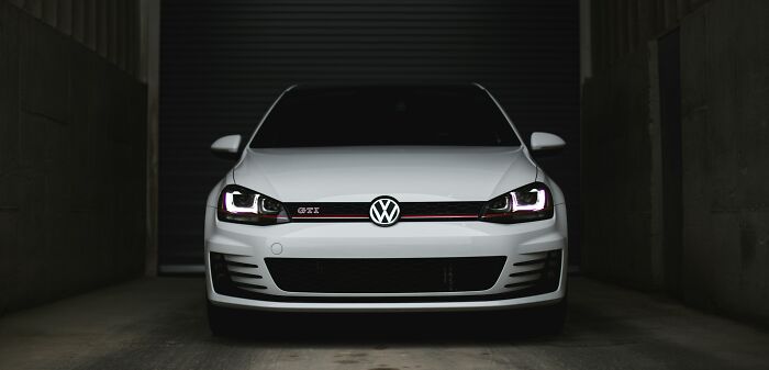White Volkswagen GTI parked in a dark garage, illustrating examples of companies sabotaging their own products.