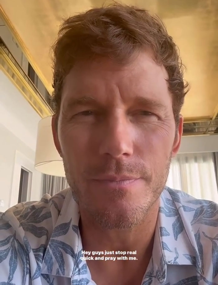 Chris Pratt close-up selfie video still in casual shirt, receiving attention for his unusual prayer style in viral clip.