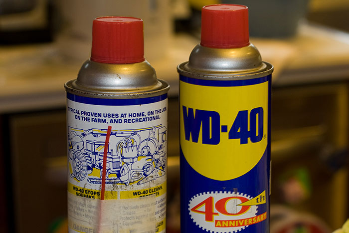 Two cans of WD-40 lubricant with red caps, illustrating ridiculous cures offered to chronically ill people.