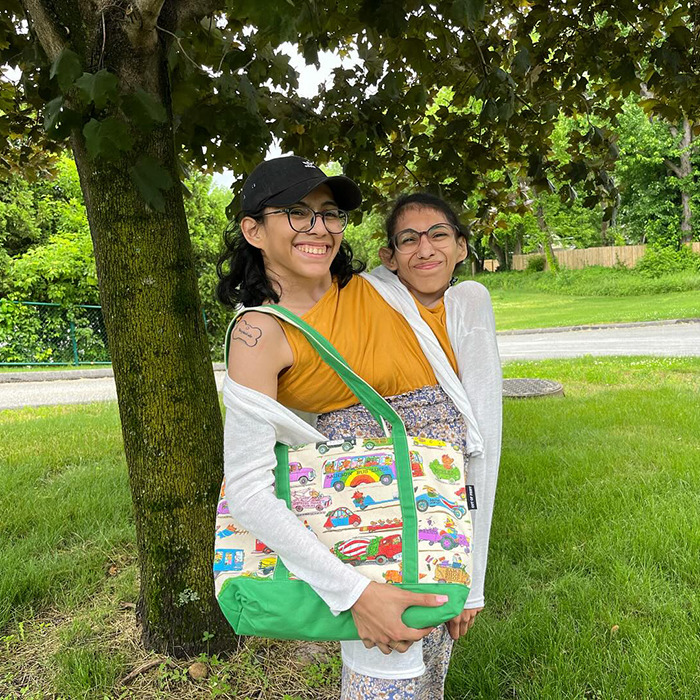 Conjoined twin smiling outdoors with husband, addressing intimacy and intrusive questions in their marriage.