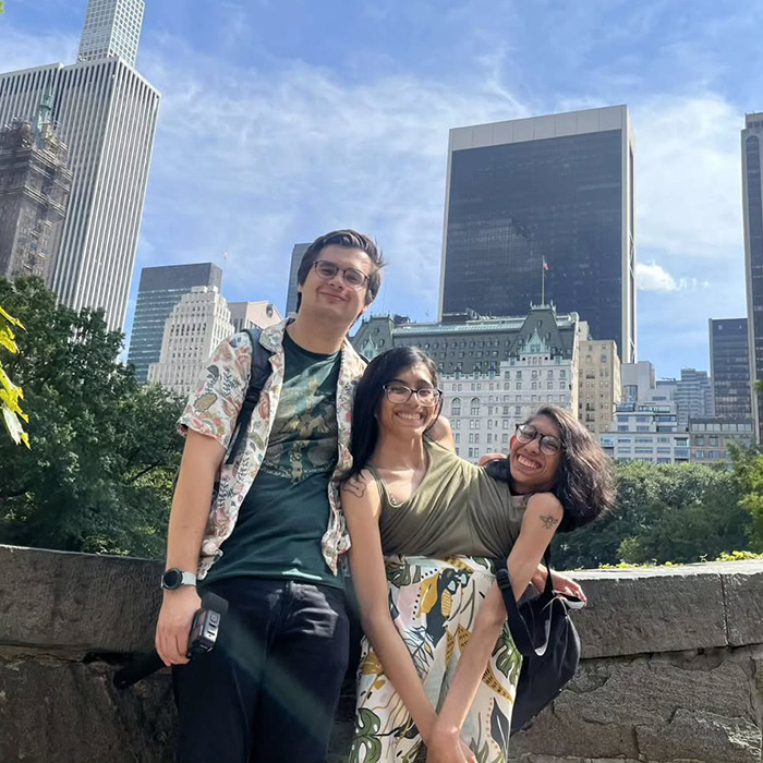 Conjoined twin and husband smiling outdoors in city setting, sharing a candid moment about intimacy and marriage.