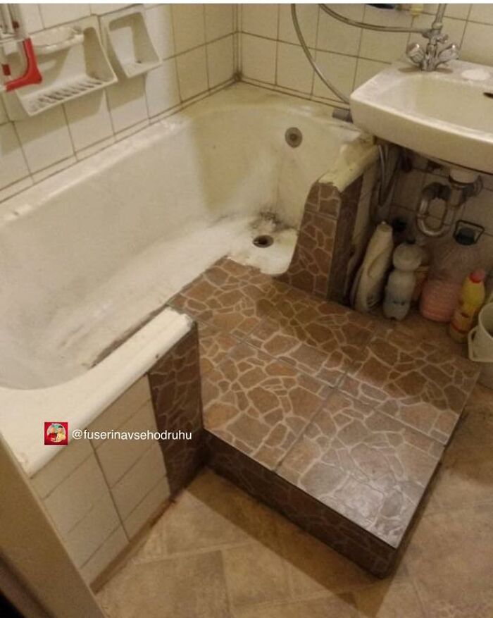 Bathtub and sink with poorly executed construction and design featuring mismatched tiles and awkward space usage.