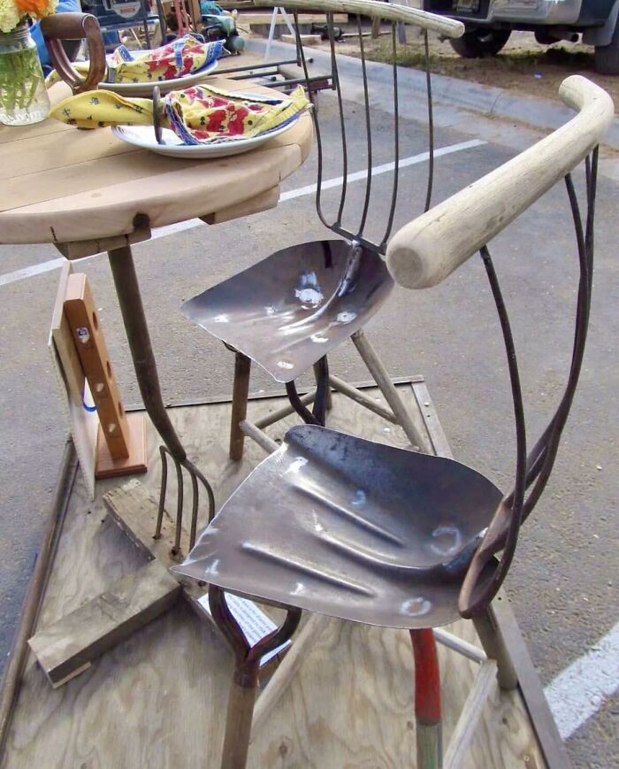 Unconventional construction and designs repurposing farming tools as chair seats in a quirky outdoor setup.