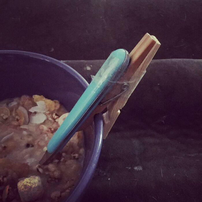 Homemade inventive tool using clothespin and pen to hold a bowl lid, showcasing kids' creativity and inventions.