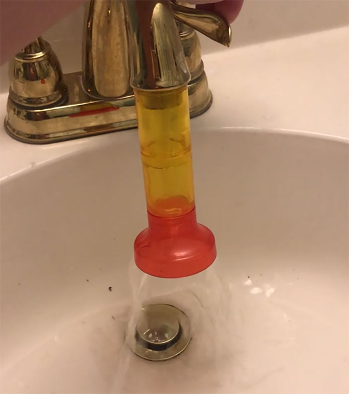 Creative kids invention showing a colorful funnel attached to a faucet directing water into a sink drain.