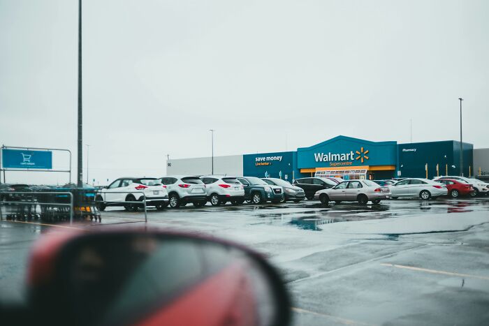Parking lot outside a Walmart on a rainy day, symbolizing stories of people who escaped death by pure luck.