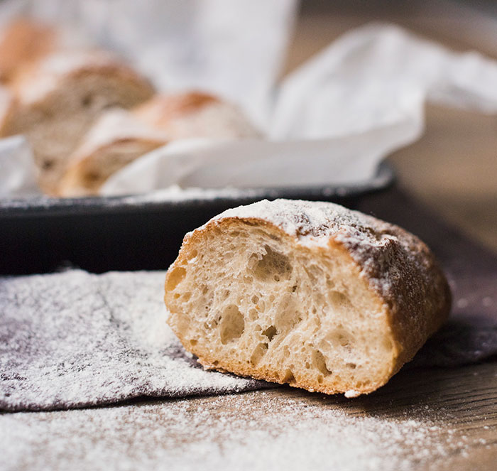 Close-up of freshly baked bread with a dusting of flour, illustrating a cozy kitchen scene for crazy things heard from MILs.