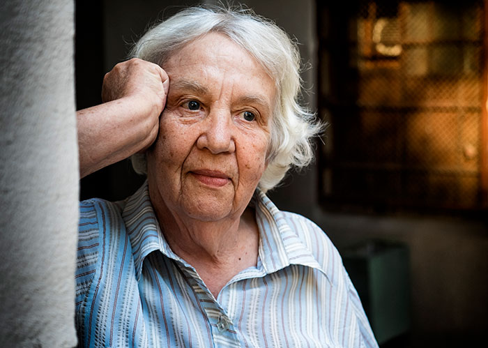 Elderly woman with white hair and striped shirt looking concerned, illustrating crazy things heard from MILs.