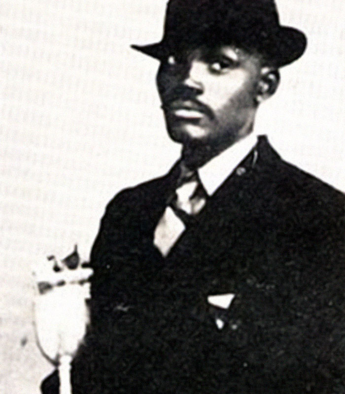 Vintage black and white photo of a man in a suit and hat, illustrating history anecdotes from the past.