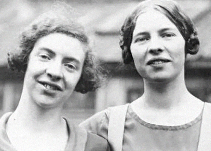 Two young women from the past smiling outdoors, an example of history anecdotes capturing everyday moments.