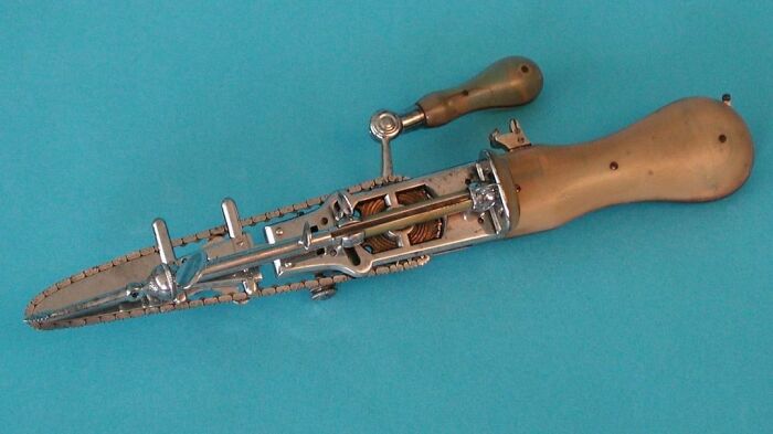 Antique mechanical hand saw with wooden handle, illustrating a unique history anecdote about past tools and inventions.