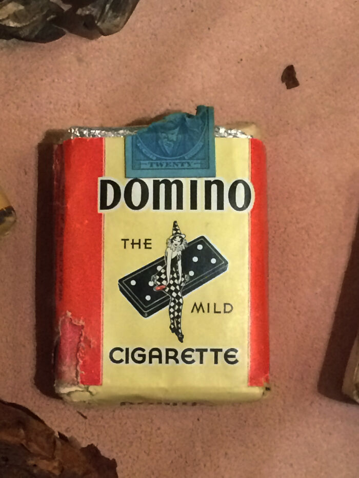 Vintage Domino cigarette pack with a clown and domino illustration, a history anecdote reflecting past smoking culture.