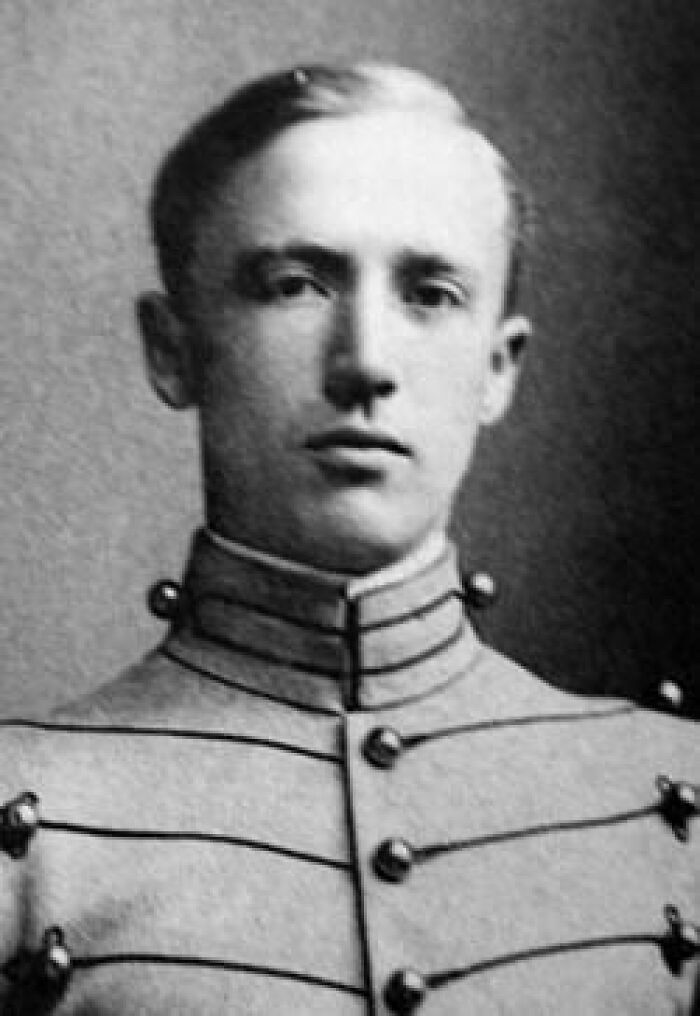 Black and white portrait of a young man in a vintage military uniform, illustrating history anecdotes from the past.