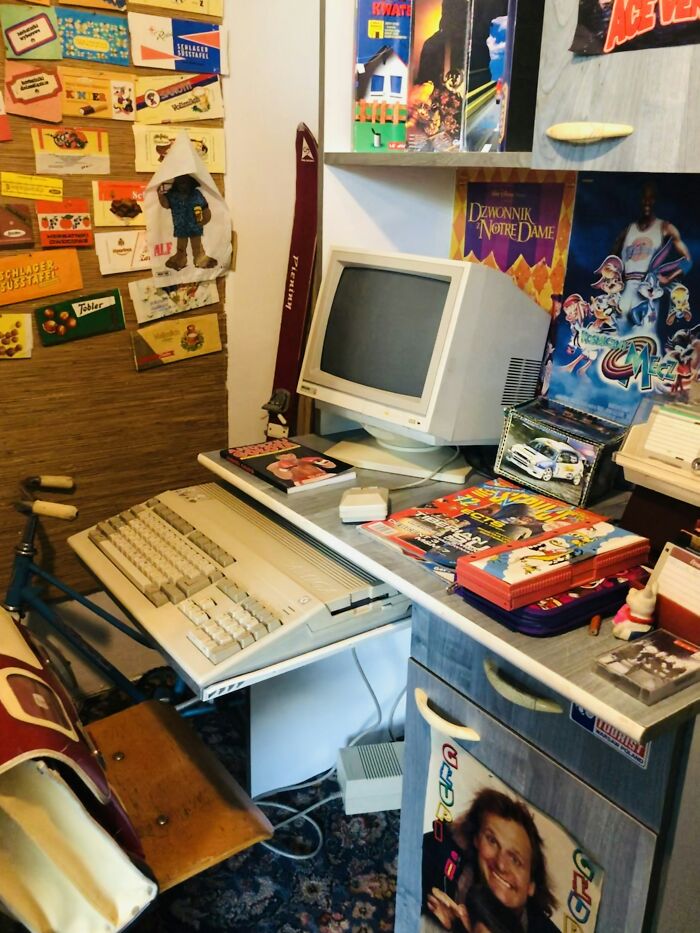 Retro cluttered desk setup with vintage computer, magazines, posters, and nostalgic items evoking bizarre messages and phone calls.