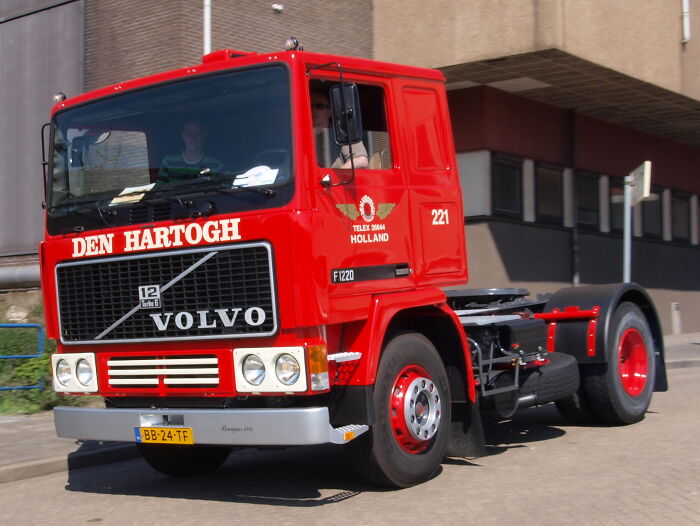 Red Volvo truck parked near a building with focus on disappearance cases keyword context for SEO purposes.