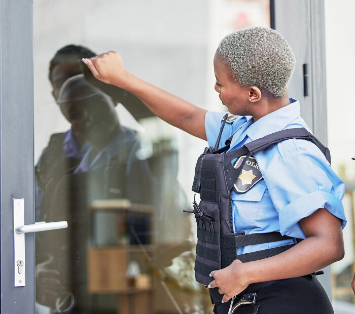 Police officer knocking on a door investigating, representing innocent people blamed by police for things they didn’t do.