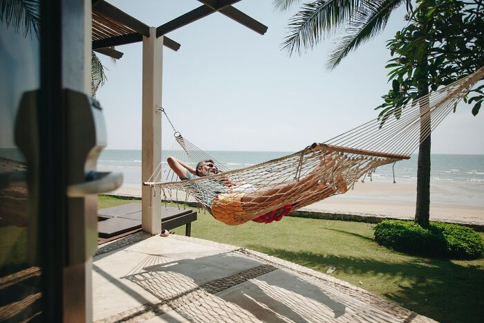 Man relaxing on a hammock by the beach symbolizing the fastest ways people have ever gotten fired.