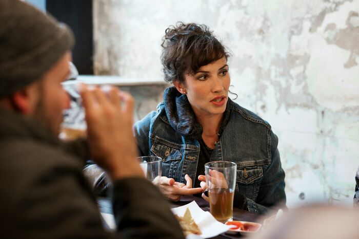 Couple having a serious conversation over drinks, illustrating signs a relationship isn’t going to last.