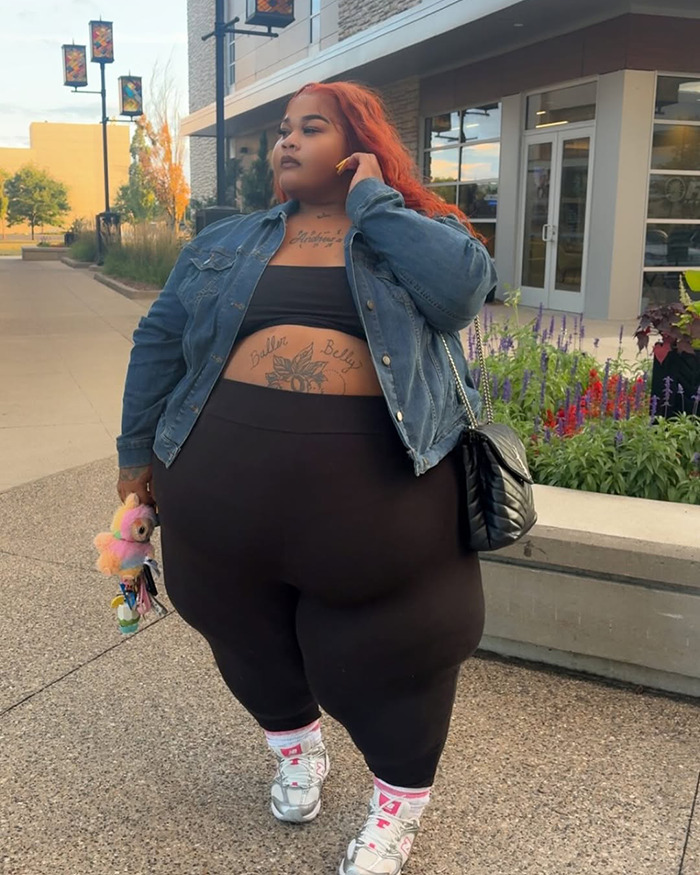 Plus-size woman with orange hair standing outdoors, representing Lyft driver denied ride due to her weight legal case.