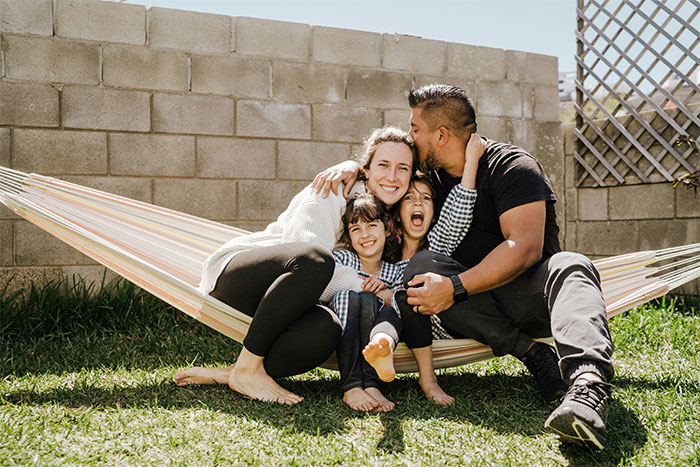 Man defending his daughter&rsquo;s space, showing love and choosing family over future with fianc&eacute;e in a backyard hammock setting.