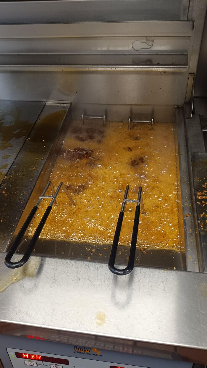 Commercial deep fryer with boiling oil and baskets frying food, illustrating anything is edible once concept.