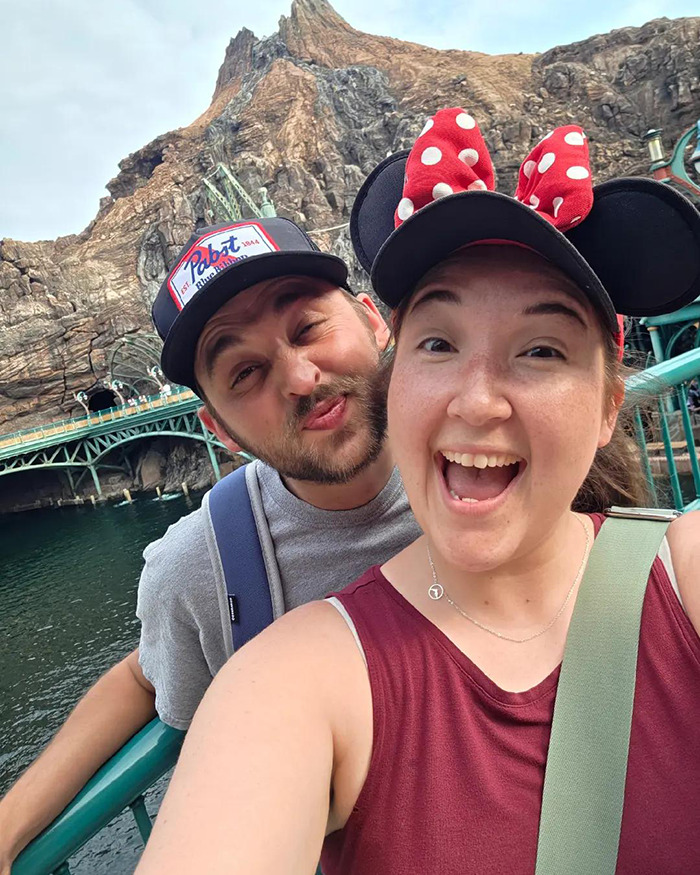 Disney influencer and husband smiling at theme park, capturing happy moment before tragic accident claims children.