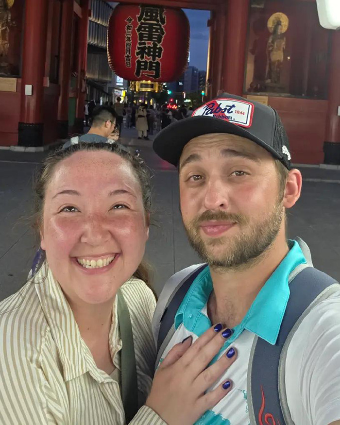 Couple smiling in an urban night setting, related to tragic accident claims Disney influencer&rsquo;s children and ICU fight.