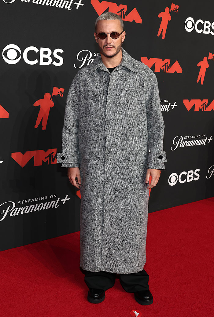 Man wearing a long grey coat and sunglasses on the red carpet at the 2025 Video Music Awards worst dressed stars.
