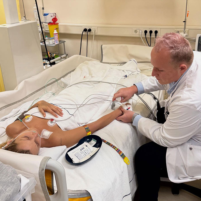 Patient Bella lying in hospital bed with doctor checking vitals, highlighting Bella's struggle and Yolanda Hadid's emotional support message
