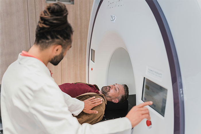 Doctor assisting patient during a health scan, highlighting common doctors health myths in medical imaging setting.
