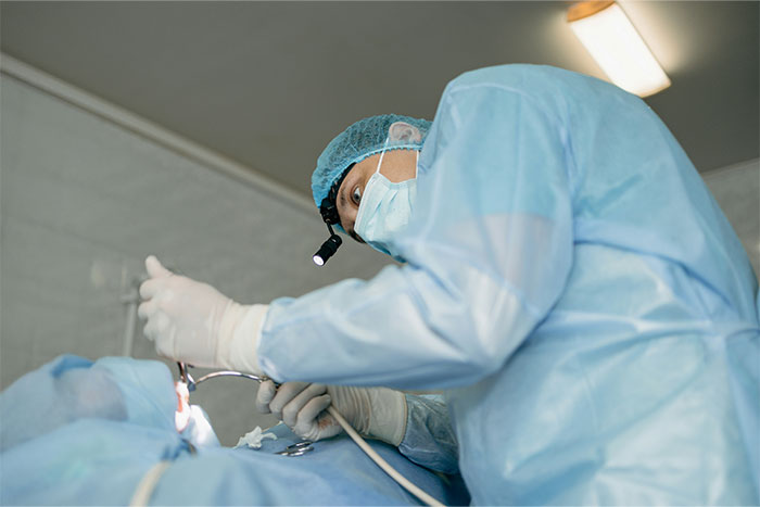 Doctor in surgical gear performing a medical procedure, illustrating doctors exposing health myths and facts.