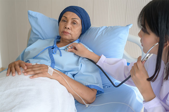 Doctor examining a patient in a hospital bed highlighting health myths doctors commonly expose and dispel.