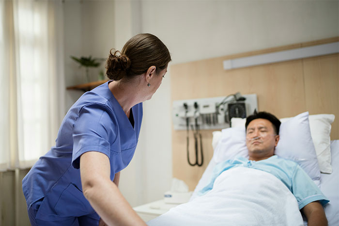 Nurse attending to a patient in a hospital bed, illustrating attempts to fake illnesses and getting exposed.