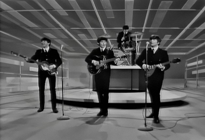 Black and white image of a band playing guitars and drums on stage, illustrating patients trying to fool doctors.