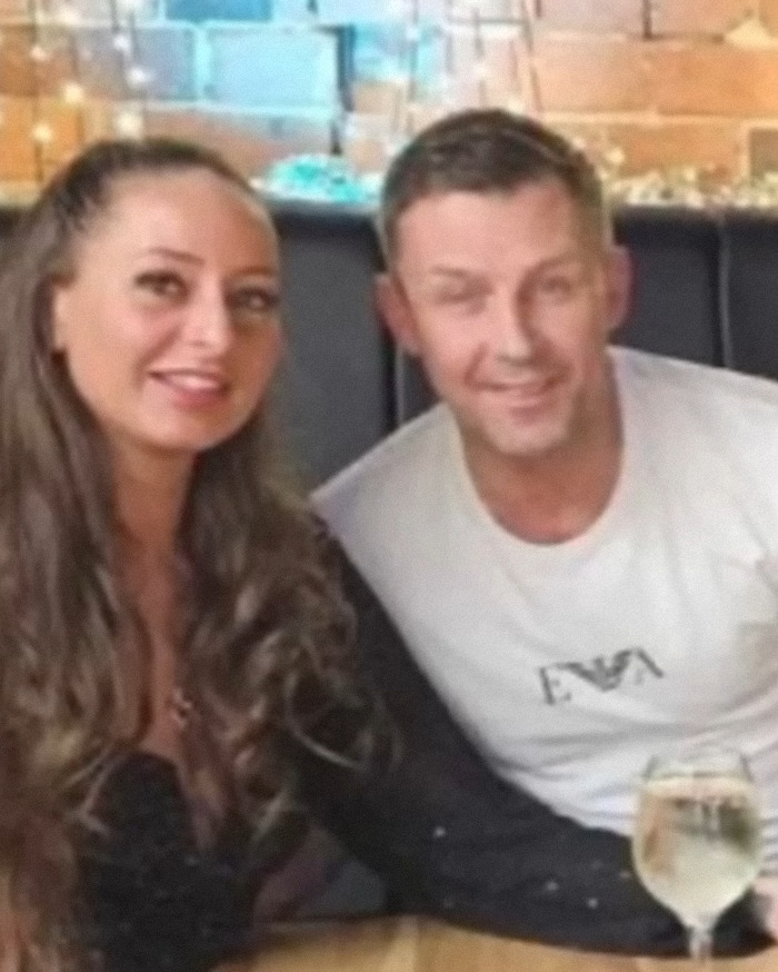 Couple sitting closely together in a restaurant, highlighting domestic violence victim story with Siri intervention.