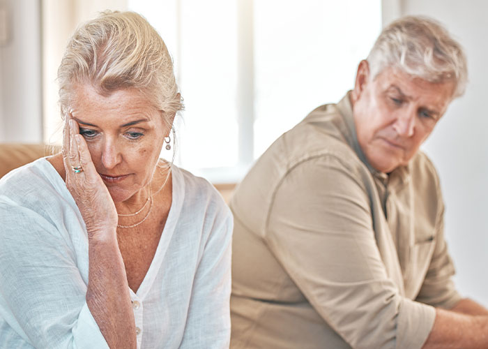 Older couple sitting apart looking upset, illustrating the consequences of people trying to live double lives and fool others.