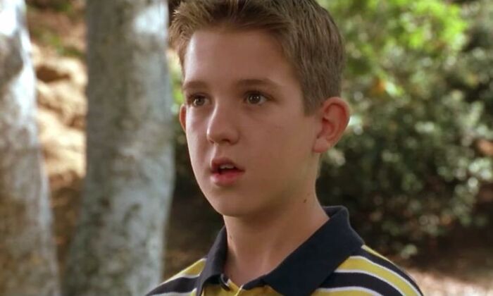 Young boy with short hair in a striped shirt outdoors, representing celebrities who vanished without a trace and spawned conspiracy theories