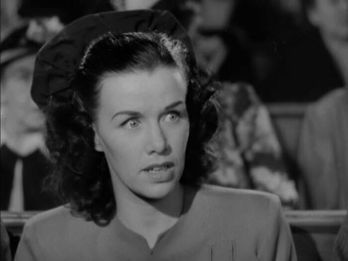 Black and white image of a concerned woman in vintage attire, representing celebrities who vanished without a trace.