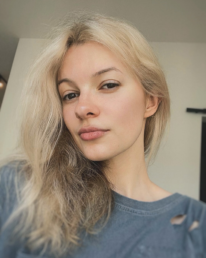 Young woman with blonde hair and a gray shirt posing for a close-up portrait related to Iryna Zarutska murals donation. Young woman with blonde hair and a gray shirt posing for a close-up portrait related to Iryna Zarutska murals donation.