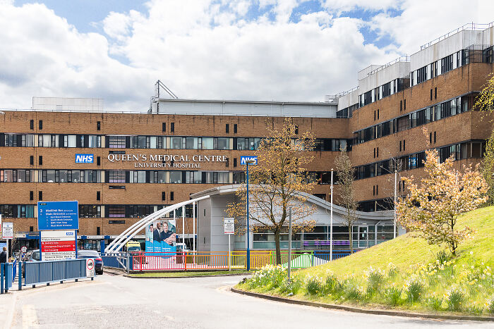 Queen's Medical Centre hospital exterior with clear sky, related to meningitis and misdiagnosed stomach bug case.