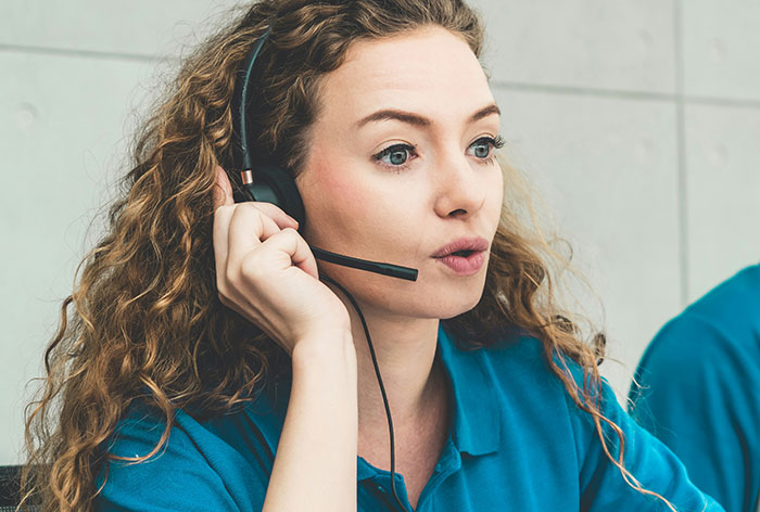 Healthcare worker with headset providing urgent support in a medical setting sharing life-saving stories.