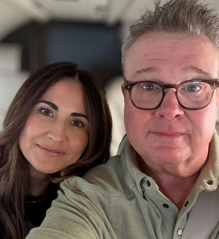 Eric Stonestreet and Jesse Tyler Ferguson posing closely together in a casual indoor setting.