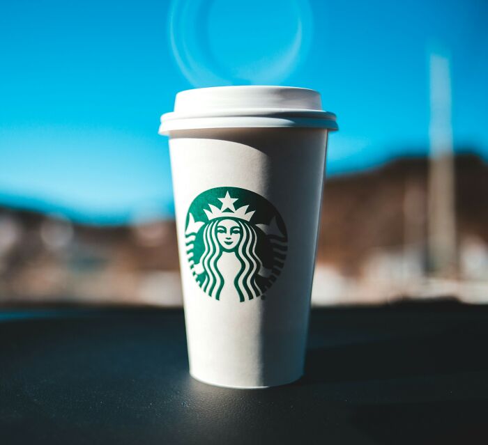 Starbucks cup with logo in sunlight representing Charlie Kirk's favorite drink and hidden hate message discovery.