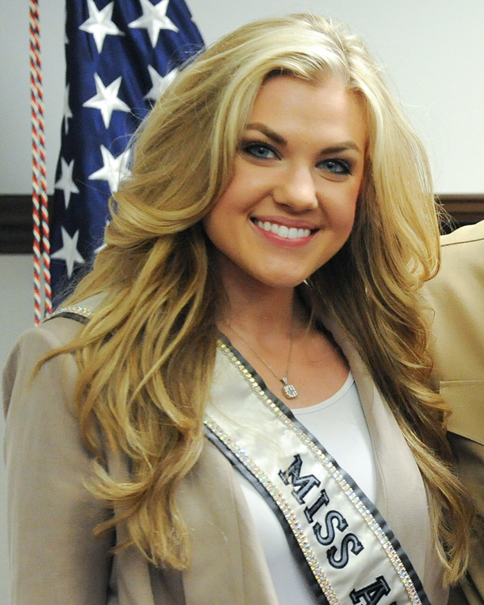 Smiling woman wearing Miss sash with blonde hair, representing Erika Kirk&rsquo;s past connection to Donald Trump as bikini photos resurface.