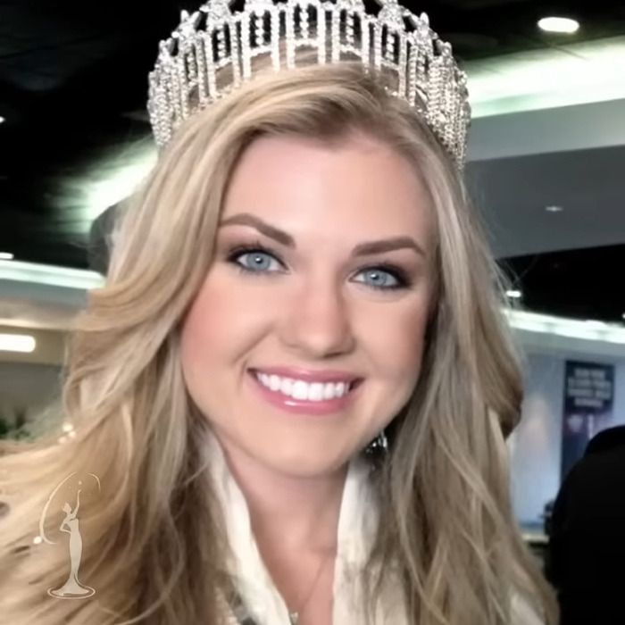Erika Kirk smiling with a crown, highlighting her past connection to Donald Trump and resurfaced bikini photos.