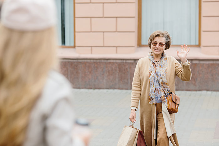 Woman showing up unannounced at ex-DIL’s doorstep, wearing glasses and waving while holding shopping bags outside a building. Woman showing up unannounced at ex-DIL’s doorstep, wearing glasses and waving while holding shopping bags outside a building.