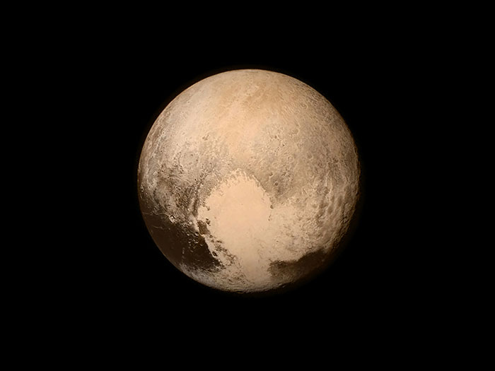 Pluto in space showing surface details, illustrating facts that sound unbelievable but are actually true about the universe.